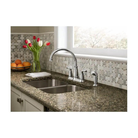 Two-Handle Chrome Kitchen Faucet With Side Spray Hose, Easy-Turn Levers For Precise Water Control, Sprayer Included, Durable Chrome Finish, Modern Convenience For Busy Home Kitchens installed on granite countertop