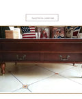 Four Piece Solid Brass Universal Caster Wheels on wooden cabinet with decorative pillows, supporting heavy load.
