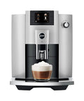 Premium Automatic Espresso Machine In Sleek Platinum Finish with milk froth ready in a glass, showcasing one touch brewing features.