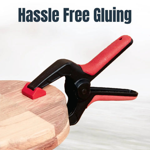 10 Pack Mini Spring Clamps With 1 Inch Opening And Pivoting Jaw Pad EZ Grip Plastic Clips securing wood piece