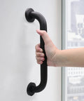 Heavy Duty 12 Inch Shower Grab Bar Built Tough For Solid Non Slip Bathroom Safety Support Rock Solid Stainless Steel Wall Mount Assist Handle In Sleek Black Finish grips held firmly by a hand.