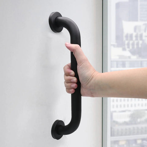 Heavy Duty 12 Inch Shower Grab Bar Built Tough For Solid Non Slip Bathroom Safety Support Rock Solid Stainless Steel Wall Mount Assist Handle In Sleek Black Finish grips held firmly by a hand.