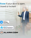 Man checking phone near entrance with Top Shelf Z Wave Deadbolt Smart Lock delivering smooth long range reach and intuitive app control.