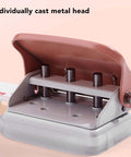 Close-up of pink handheld 3 hole paper punch for binders with metal head, punches up to five pages at once, 5.5mm holes, 19mm spacing