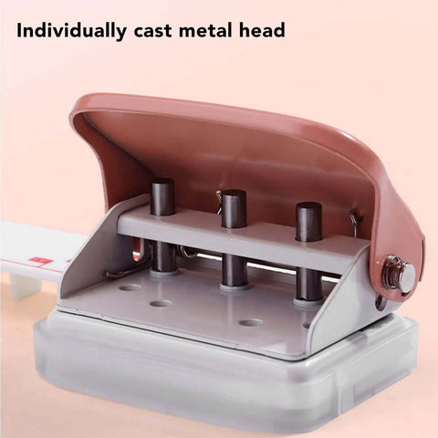 Close-up of pink handheld 3 hole paper punch for binders with metal head, punches up to five pages at once, 5.5mm holes, 19mm spacing