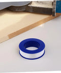 12 Rolls PTFE Plumbers Tape Sealing Tape For Faucet Leaks And High Temperature Plumbing Pipe Sealant For Home Garden DIY Repairs Prevents Leaks And Extends Pipe Life on a white surface next to a workshop tool.