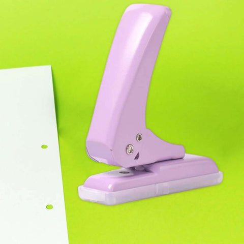 Purple Pro Grade 40 Sheet Single Hole Punch with Non Slip Base 5.5mm Hole Adjustable Punch Position on green background