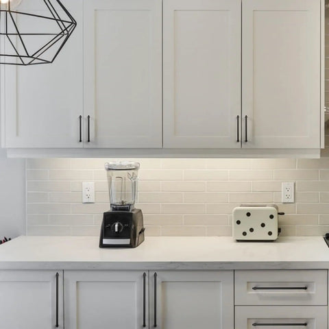Sleek Matte Black Cabinet Pulls 10 Pack Five Inch Drawer Handles on modern white cabinets with blender and toaster.