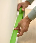 Applying PaintBlock Multi Surface Painter Tape 2 Inch Wide for Sharp Lines Green 3 Rolls 1.88 in x 60 Yds on wall edge