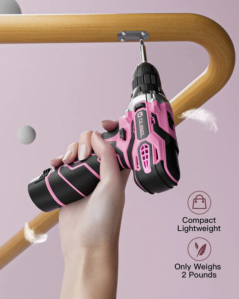 Hand using Pink Cordless Drill Set For Women With 12 Volt Power on a wooden surface, showing compact, lightweight design.