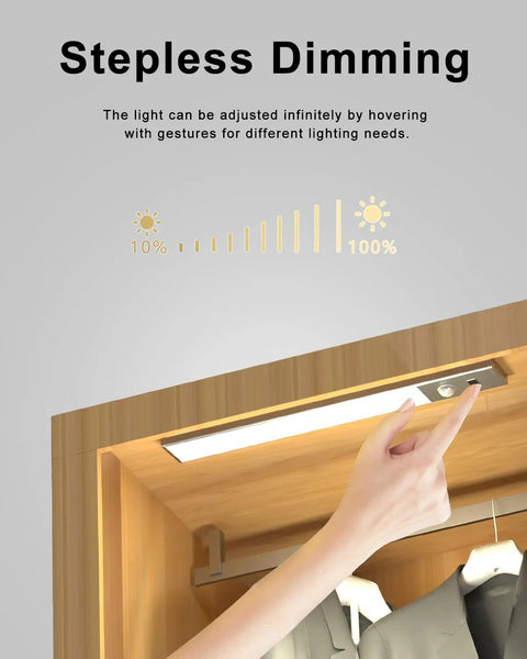 Hand adjusting 30 LED Motion Sensor Under Cabinet Light With Dimmable USB Rechargeable Night Lighting in wardrobe.