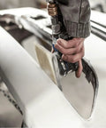 Close-up of a hand using a sanding tool on a white surface with a mesh sanding disc from the Premium 50 Pack Mesh Sanding Discs 198x70mm Dry Polishing.
