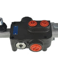 Hydraulic directional control valve, side view; black body, red port plugs, blue nameplate.