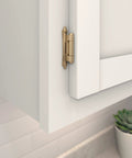 Solid Construction Self Closing Cabinet Hinges In Sweet Champagne Bronze mounted on a white cabinet for face frame doors.