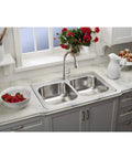 Single Hole Deck Mount Kitchen Faucet With Pull Down Sprayer And Forward Only Lever Chrome ADA Compliant Lead Free Certification NSF ANSI 61 372 Solid Brass Waterways Includes Two Aerators Easy Install installed on a marble countertop with a double sink and red flowers.