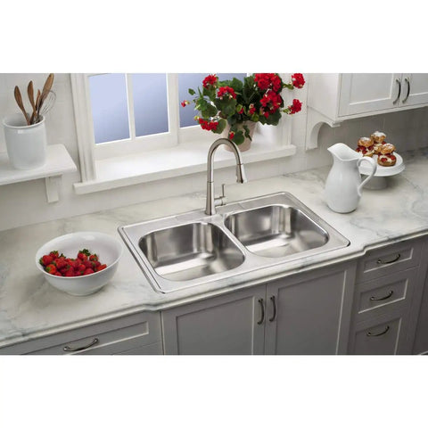 Single Hole Deck Mount Kitchen Faucet With Pull Down Sprayer And Forward Only Lever Chrome ADA Compliant Lead Free Certification NSF ANSI 61 372 Solid Brass Waterways Includes Two Aerators Easy Install installed on a marble countertop with a double sink and red flowers.