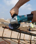 Workhorse High-Power 4 1/2 Inch Angle Grinder With SJS Mechanical Clutch cutting metal rebar on construction site