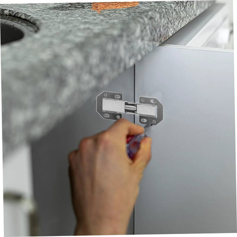 Silver metal wardrobe hinge repair kit being installed on cabinet door with screwdriver