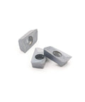 APMT1604PDER-M2 carbide inserts, set of 3 gray with central through-hole (front view)