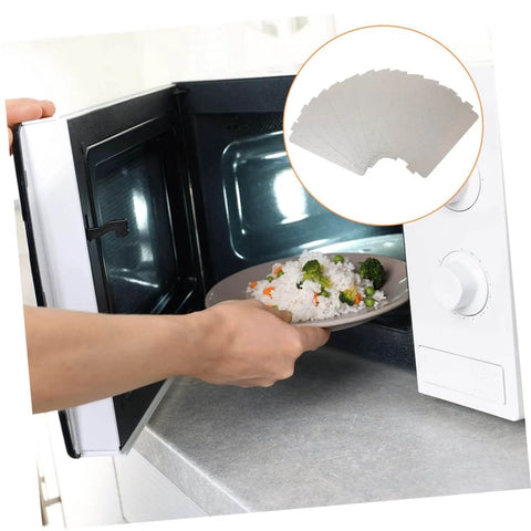 Person placing food in a microwave, illustrating the use of Six Pack Microwave Mica Sheet Heat Insulation Covers For Everyday Use