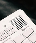 Close-up of a Compact Finger Drum Pad with 18 touch sensitive pads, built-in sounds, USB connectivity, integrated speaker, rechargeable battery.