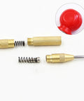 Slick Badass Automatic Center Punch For Metal And Woodworking disassembled with gold finish brass and spring mechanism for drill alignment.