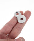 Double Hole Tabletop Metal Connectors With Screws Prepunched Silver Fastener Plates held between fingers