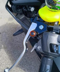 3Pcs CNC M10x1.25 Motorcycle Mirror Hole Plug installed on a motorcycle handlebar, orange finish