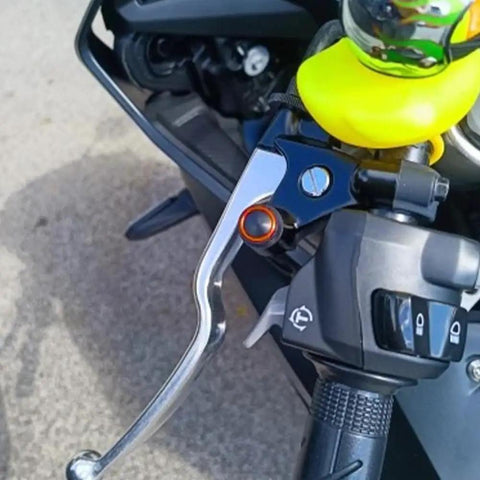 3Pcs CNC M10x1.25 Motorcycle Mirror Hole Plug installed on a motorcycle handlebar, orange finish