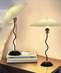 Harp Folding Lamp Set Two Pieces, Modern Umbrella Pleated Desk Lamp With White Shade, Beige PVC, Iron Base on bedside table