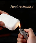 No Sweat Mastic Flex 26 PCS White Waterproof Sealant Clay For Patching Wall Holes Plugging AC Vents And Drainage Pipes Easy Indoor Outdoor Putty Fix With Total Crackdown On Drafts And Water Leaks Every Time, shown being tested for heat resistance.