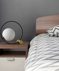 Mid Century Modern Glass Globe Desk Lamp With Gold Ring on bedside table, bedroom setting, frosted shade, ambient glow