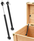 Two Pack 15 Inch Toy Box Hinges With 150N Gas Strut For Slow Gentle Close displayed with wooden chest
