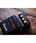 Waza Craft HM-2W Heavy Metal Guitar Pedal with orange knobs on a wooden surface, delivers legendary chainsaw tone.