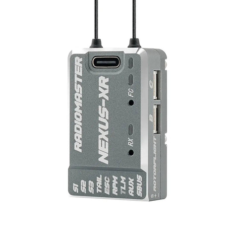 Nexus-XR Helicopter Flight Controller With Integrated 2.4GHz ExpressLRS Receiver, silver casing with multiple ports and antennae.