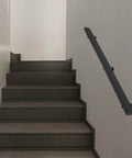 Rock Solid Flush Wall Mount Stair Handrail Built Like A Tank Using Premium Stainless Steel With Beast Mode Two Hundred Pound Load Rating And A Clean Modern Profile Designed To Last Forever on a staircase.