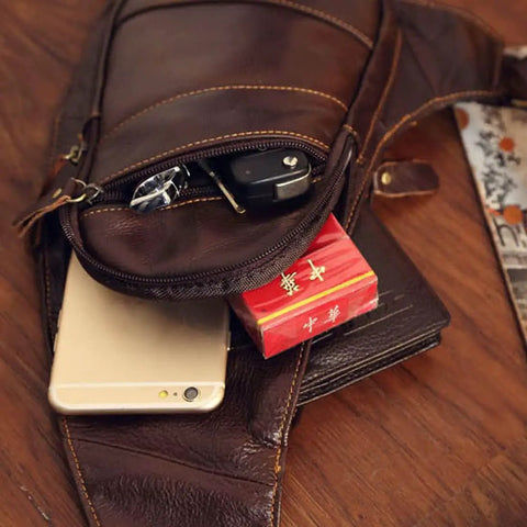 Genuine Leather Sling Backpack For Men And Women Crossbody Day Pack open with phone and essentials visible, in brown cowhide leather.