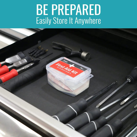 Front view of a clear DMI 76-piece first-aid kit with a red label in a tool-drawer.