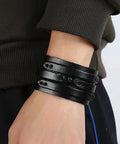 Two Piece Punk Leather Cuff Bracelet Set Vintage Wristband For Men And Women, adjusted black leather wristbands on wrist.