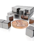 Super Badass N48 Neodymium Cube Magnets 1/4 Inch 6Mm size with a penny for scale on a white background.