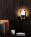 Modern Geometric Wall Sconce With 15 Watt Led Bulb And Sleek Aluminum Iron Frame For Bedroom Nightstand Setup Or Living Room Accent Lighting Super Chic Home Vibes Easy Wall Mount Soft Glow Lamp mounted beside a cozy bed.