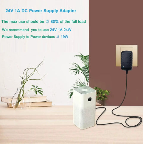 Budget Friendly 24V DC 1A Power Supply Adapter For LED Strips And CCTV Cameras plugged into wall outlet with connected device