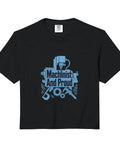 Cool Machinist Gifts For Guys: Boxy Cut Crop Top With Vise Gauge Square And Metal Tool Designs Made From Soft Heavyweight Cotton In Beige, featuring a blue ‘Machinist And Proud’ graphic on black fabric.