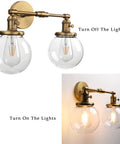 Industrial Style Double Wall Sconce Light, Hardwired, 5.9 Inch Round Clear Glass Shade, On Off Switch, brass finish, E26 socket.