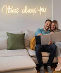 Couple on couch with 'It Was Always You Neon Sign For Weddings And Anniversaries, Engagements, Birthdays And Parties'