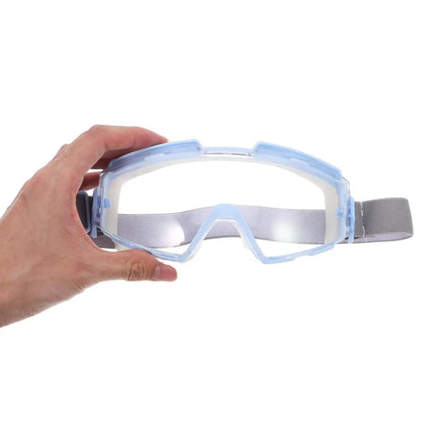 Heavy Duty Blue Safety Goggles With Anti Fog Ventilation And Side Shields being held, showing clear lenses and elastic strap.