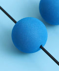 Close-up of blue sponge ball from RC Helicopter Landing Gear Training Kit with black rod, stable flight cushion.