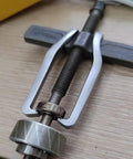 Heavy Duty 2 Jaw Puller With Single Hook Lifting Tool in use, chrome vanadium steel, extracting bearing from hub.