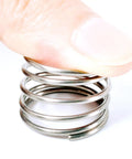 Close-up of zinc plated metal wire spring from Heavy Duty Spring Assortment Kit With 200 Extension Springs for shop repairs.