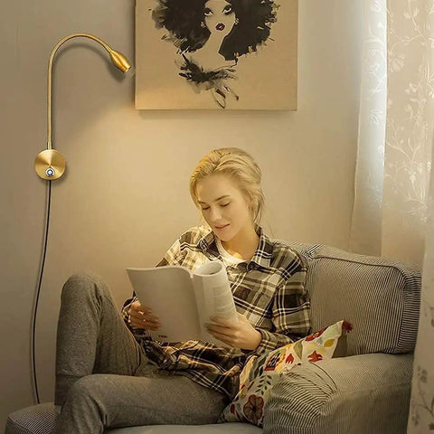 Woman reading under dimmable LED reading lamp for wall mounting on bed headboard flexible gooseneck with touch dimmer plug in wired sconce.